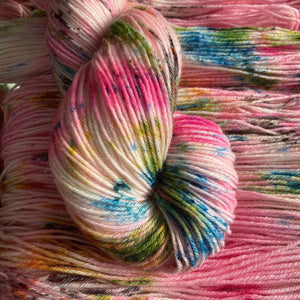 IxCHeL Fibre & Yarns - A single skeined yarn sitting on many other yarns