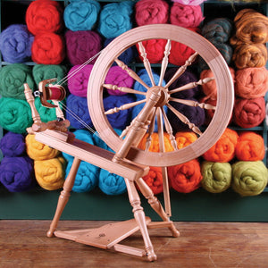 IxCHeL Fibre & Yarns - Ashford Spinning Wheels with a colourful selection of wool bumps behind it.